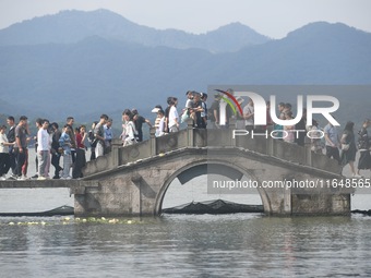 Crowds of people gather at West Lake during the National Day holiday in Hangzhou, China, on October 2, 2024. On October 8, 2024, according t...