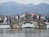 Crowds of people gather at West Lake during the National Day holiday in Hangzhou, China, on October 2, 2024. On October 8, 2024, according t...