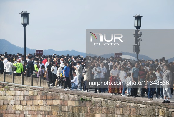 Crowds of people gather at West Lake during the National Day holiday in Hangzhou, China, on October 2, 2024. On October 8, 2024, according t...