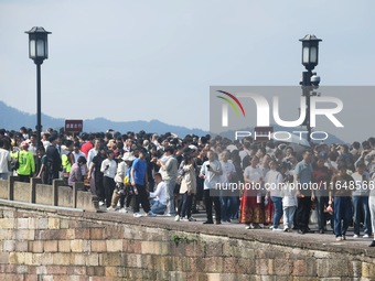 Crowds of people gather at West Lake during the National Day holiday in Hangzhou, China, on October 2, 2024. On October 8, 2024, according t...