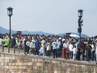 Crowds of people gather at West Lake during the National Day holiday in Hangzhou, China, on October 2, 2024. On October 8, 2024, according t...