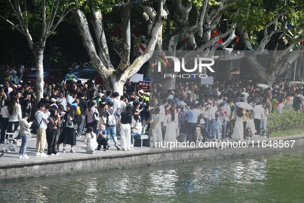 Crowds of people gather at West Lake during the National Day holiday in Hangzhou, China, on October 2, 2024. On October 8, 2024, according t...