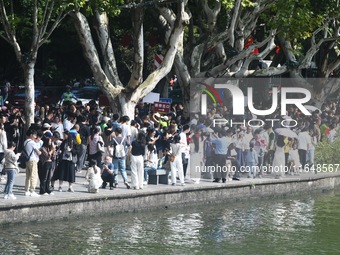 Crowds of people gather at West Lake during the National Day holiday in Hangzhou, China, on October 2, 2024. On October 8, 2024, according t...