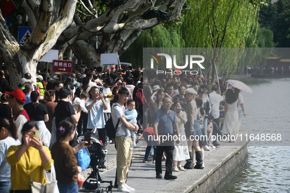 Crowds of people gather at West Lake during the National Day holiday in Hangzhou, China, on October 2, 2024. On October 8, 2024, according t...