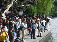 Crowds of people gather at West Lake during the National Day holiday in Hangzhou, China, on October 2, 2024. On October 8, 2024, according t...