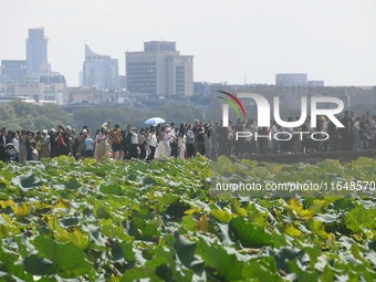 Crowds of people gather at West Lake during the National Day holiday in Hangzhou, China, on October 2, 2024. On October 8, 2024, according t...