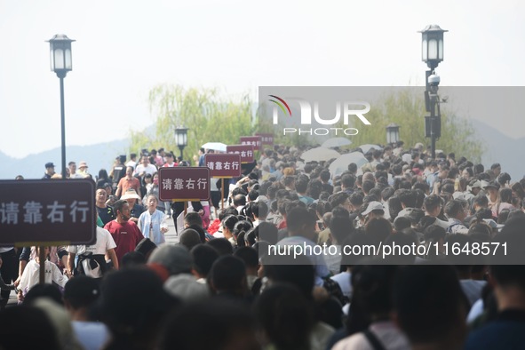 Crowds of people gather at West Lake during the National Day holiday in Hangzhou, China, on October 2, 2024. On October 8, 2024, according t...