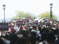 Crowds of people gather at West Lake during the National Day holiday in Hangzhou, China, on October 2, 2024. On October 8, 2024, according t...