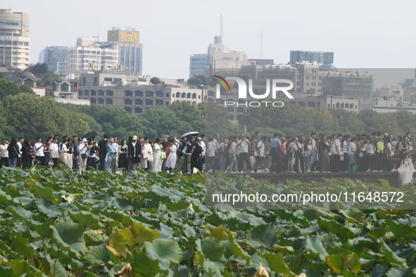 Crowds of people gather at West Lake during the National Day holiday in Hangzhou, China, on October 2, 2024. On October 8, 2024, according t...