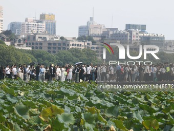 Crowds of people gather at West Lake during the National Day holiday in Hangzhou, China, on October 2, 2024. On October 8, 2024, according t...