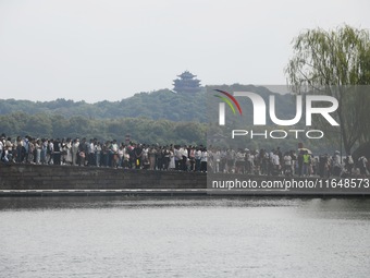 Crowds of people gather at West Lake during the National Day holiday in Hangzhou, China, on October 2, 2024. On October 8, 2024, according t...