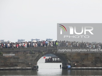 Crowds of people gather at West Lake during the National Day holiday in Hangzhou, China, on October 2, 2024. On October 8, 2024, according t...