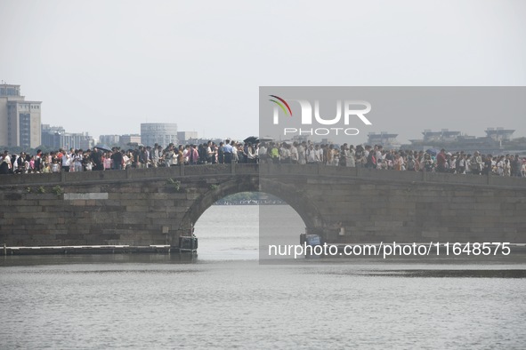 Crowds of people gather at West Lake during the National Day holiday in Hangzhou, China, on October 2, 2024. On October 8, 2024, according t...