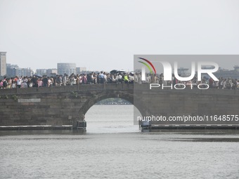 Crowds of people gather at West Lake during the National Day holiday in Hangzhou, China, on October 2, 2024. On October 8, 2024, according t...