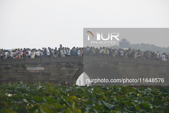 Crowds of people gather at West Lake during the National Day holiday in Hangzhou, China, on October 2, 2024. On October 8, 2024, according t...