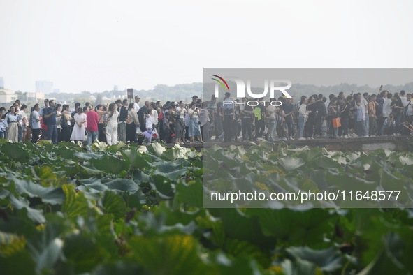 Crowds of people gather at West Lake during the National Day holiday in Hangzhou, China, on October 2, 2024. On October 8, 2024, according t...