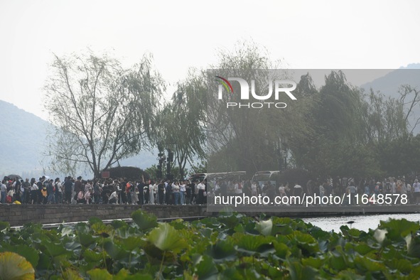 Crowds of people gather at West Lake during the National Day holiday in Hangzhou, China, on October 2, 2024. On October 8, 2024, according t...