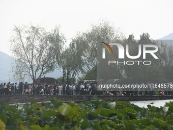 Crowds of people gather at West Lake during the National Day holiday in Hangzhou, China, on October 2, 2024. On October 8, 2024, according t...