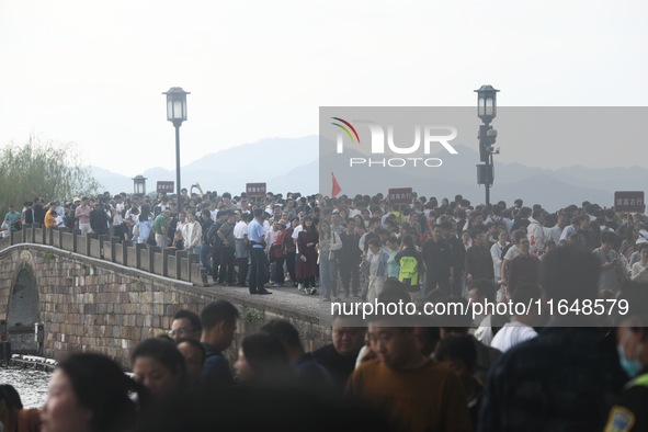 Crowds of people gather at West Lake during the National Day holiday in Hangzhou, China, on October 2, 2024. On October 8, 2024, according t...