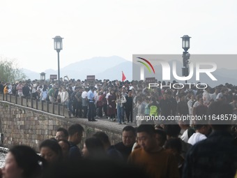 Crowds of people gather at West Lake during the National Day holiday in Hangzhou, China, on October 2, 2024. On October 8, 2024, according t...