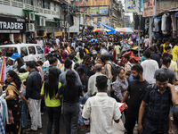 A crowd of people shops at a street market ahead of the Durga Puja festival in Guwahati, India, on October 7, 2024. Shopping ahead of Durga...