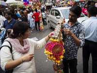 A woman buys decorative items at a street market ahead of the Durga Puja festival in Guwahati, India, on October 7, 2024. Shopping ahead of...