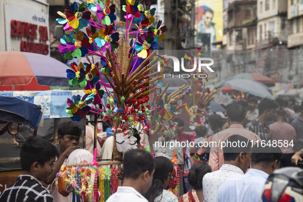 A vendor sells toys and other children's items at a street market ahead of the Durga Puja festival in Guwahati, India, on October 7, 2024. S...