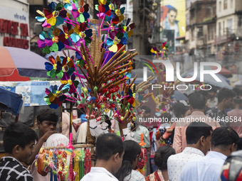 A vendor sells toys and other children's items at a street market ahead of the Durga Puja festival in Guwahati, India, on October 7, 2024. S...