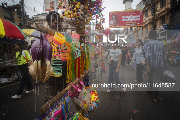 A vendor sells toys and other children's items at a street market ahead of the Durga Puja festival in Guwahati, India, on October 7, 2024. S...