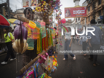 A vendor sells toys and other children's items at a street market ahead of the Durga Puja festival in Guwahati, India, on October 7, 2024. S...