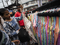 People buy clothes at a street market ahead of the Durga Puja festival in Guwahati, India, on October 7, 2024. Shopping ahead of Durga Puja...