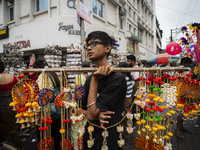 A boy sells decorative items at a street market ahead of the Durga Puja festival in Guwahati, India, on October 7, 2024. Shopping ahead of D...