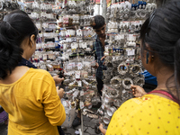 A woman buys jewelry at a street market ahead of the Durga Puja festival in Guwahati, India, on October 7, 2024. Shopping ahead of Durga Puj...