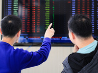 Investors pay attention to the stock market at a securities sales department in Nanjing, China, on October 8, 2024. (