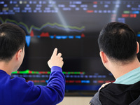 Investors pay attention to the stock market at a securities sales department in Nanjing, China, on October 8, 2024. (