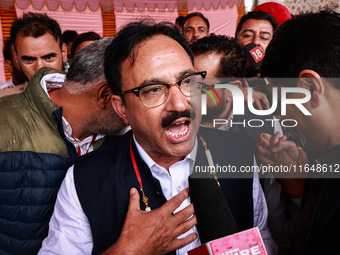 Sajad Shafi, the National Conference winning candidate from Audi, speaks to the media outside the counting center during assembly election r...