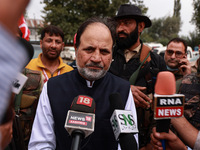 Javid Hassan Baig, the National Conference winning candidate from Baramulla, speaks to the media outside the counting center during assembly...