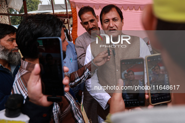 Javid Ahmad Dar, the National Conference winning candidate from Rafiabad, speaks to the media outside the counting center during assembly el...