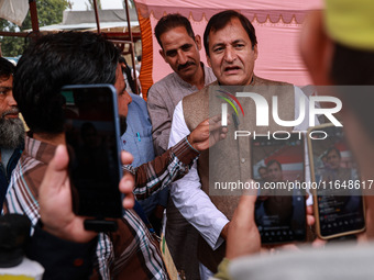 Javid Ahmad Dar, the National Conference winning candidate from Rafiabad, speaks to the media outside the counting center during assembly el...