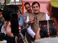 Javid Ahmad Dar, the National Conference winning candidate from Rafiabad, speaks to the media outside the counting center during assembly el...