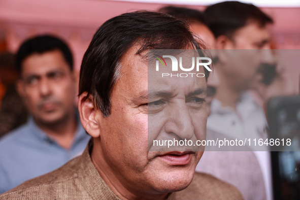 Javid Ahmad Dar, the National Conference winning candidate from Rafiabad, speaks to the media outside the counting center during assembly el...