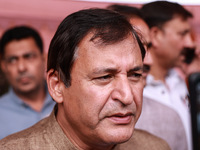 Javid Ahmad Dar, the National Conference winning candidate from Rafiabad, speaks to the media outside the counting center during assembly el...