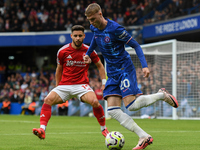 Cole Palmer of Chelsea is under pressure from Alex Moreno of Nottingham Forest during the Premier League match between Chelsea and Nottingha...