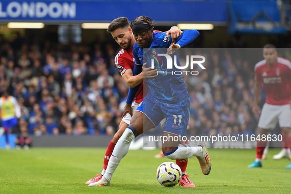 Alex Moreno of Nottingham Forest battles with Noni Madueke of Chelsea during the Premier League match between Chelsea and Nottingham Forest...