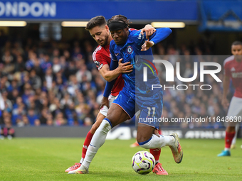 Alex Moreno of Nottingham Forest battles with Noni Madueke of Chelsea during the Premier League match between Chelsea and Nottingham Forest...