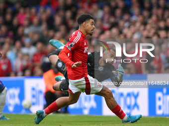 Robert Sanchez, Chelsea goalkeeper, dives as Morgan Gibbs-White of Nottingham Forest watches the ball after Chris Wood of Nottingham Forest...