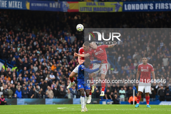 Nikola Milenkovic of Nottingham Forest and James Ward-Prowse of Nottingham Forest battle with Nicolas Jackson of Chelsea during the Premier...