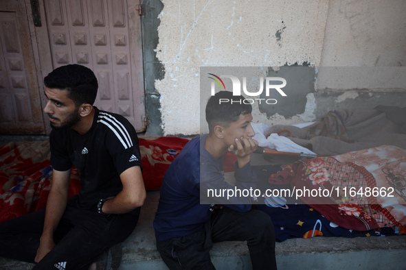 Palestinians mourn their relatives who are killed in overnight Israeli airstrikes on the Al-Bureij refugee camp in central Gaza at the Al-Aq...