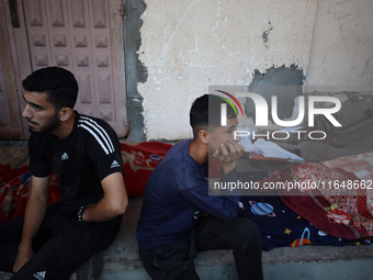 Palestinians mourn their relatives who are killed in overnight Israeli airstrikes on the Al-Bureij refugee camp in central Gaza at the Al-Aq...