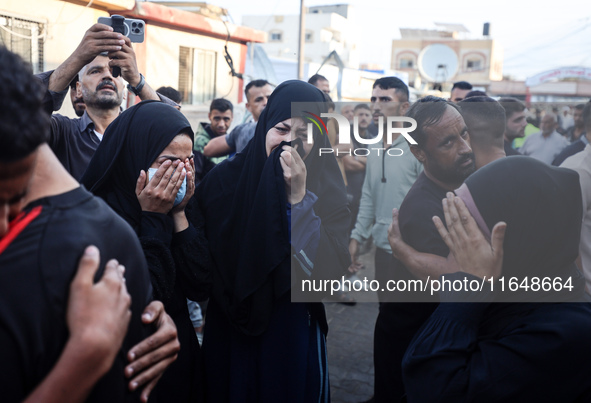 Palestinians mourn their relatives who are killed in overnight Israeli airstrikes on the Al-Bureij refugee camp in central Gaza at the Al-Aq...